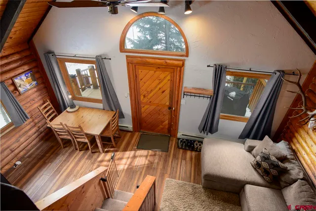 a view of a livingroom with furniture window and wooden floor