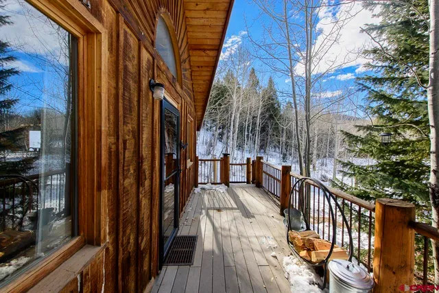 a view of a balcony with wooden floor and stairs