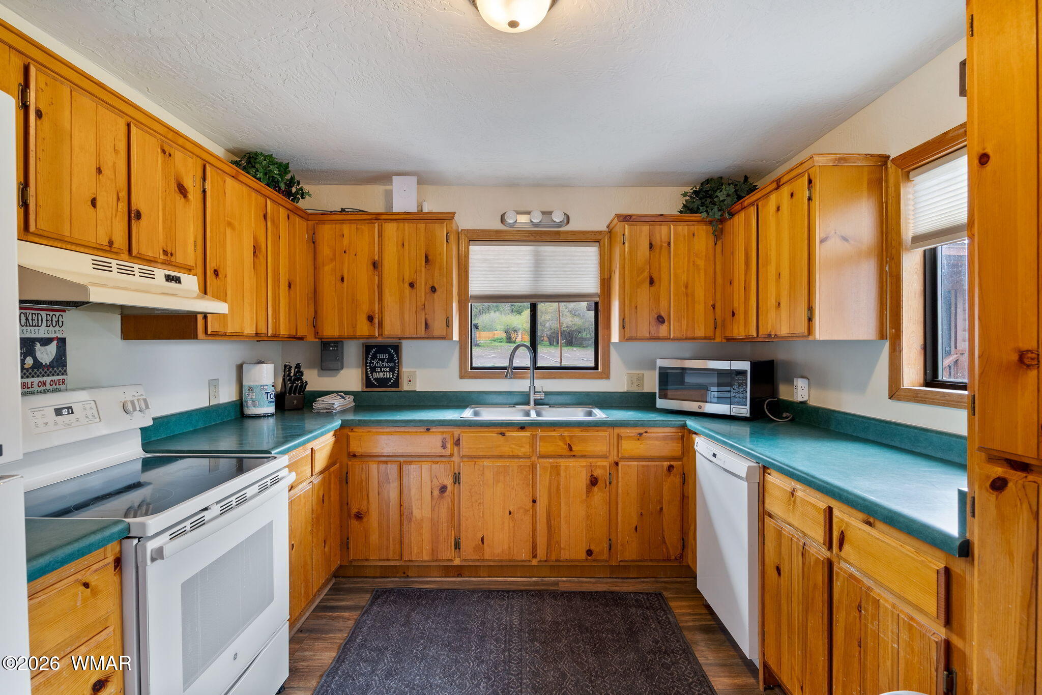 85 Main Street Greer, AZ 85927 - Photo 14 of 55 a kitchen with stainless steel appliances a sink cabinets and a large window