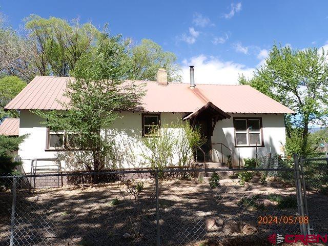 21196 Lanning Road Austin, CO 81410 - Photo 1 of 12 a front view of a house with a yard