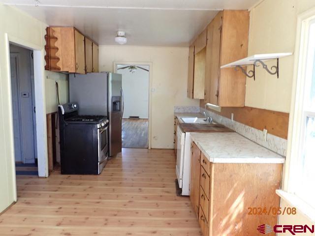 21196 Lanning Road Austin, CO 81410 - Photo 8 of 12 a kitchen with granite countertop a refrigerator and a sink