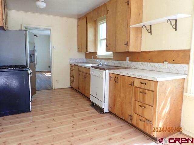 21196 Lanning Road Austin, CO 81410 - Photo 9 of 12 a view of a kitchen with cabinets and wooden floor