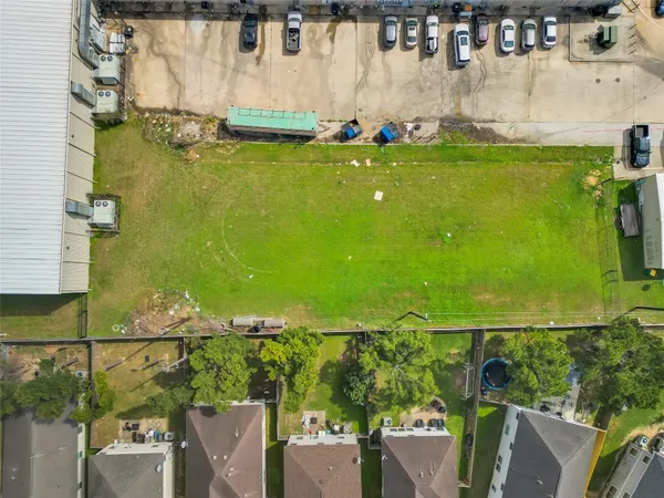 an aerial view of residential houses with outdoor space and swimming pool
