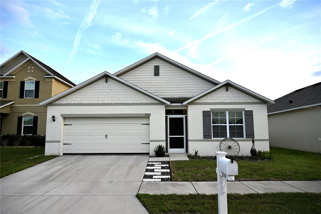 a front view of a house with a yard and garage