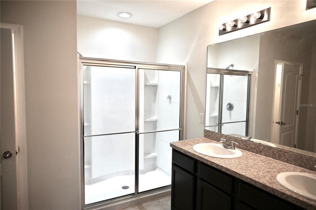 1036 Bethpage Road Auburndale, FL 33823 - Photo 12 of 18 a bathroom with a granite countertop sink and a mirror