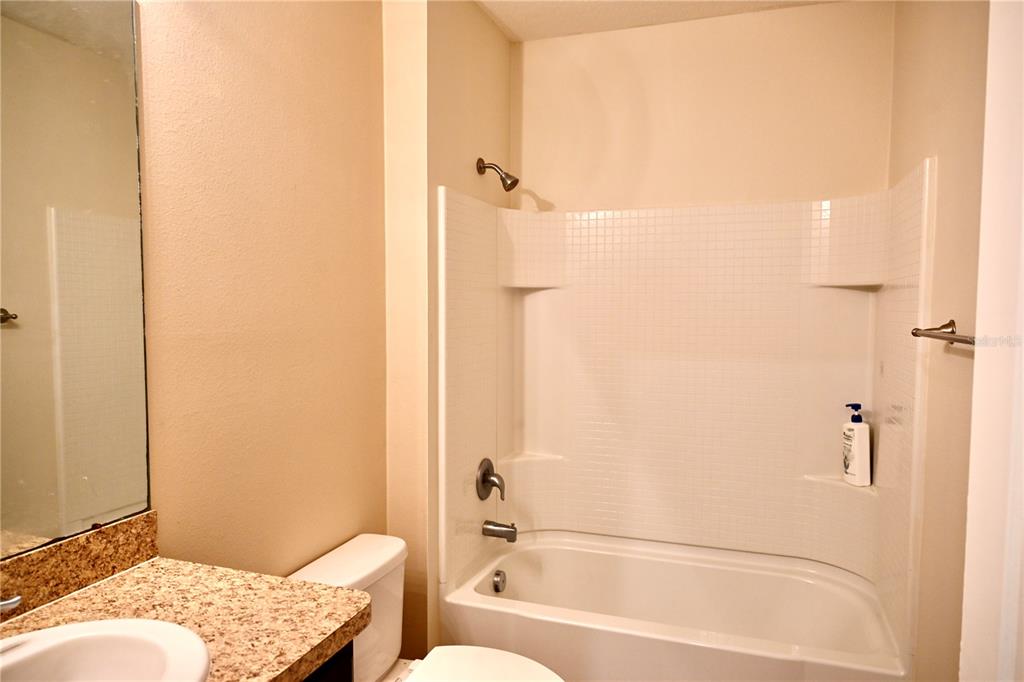 1036 Bethpage Road Auburndale, FL 33823 - Photo 15 of 18 a bathroom with a tub and a shower