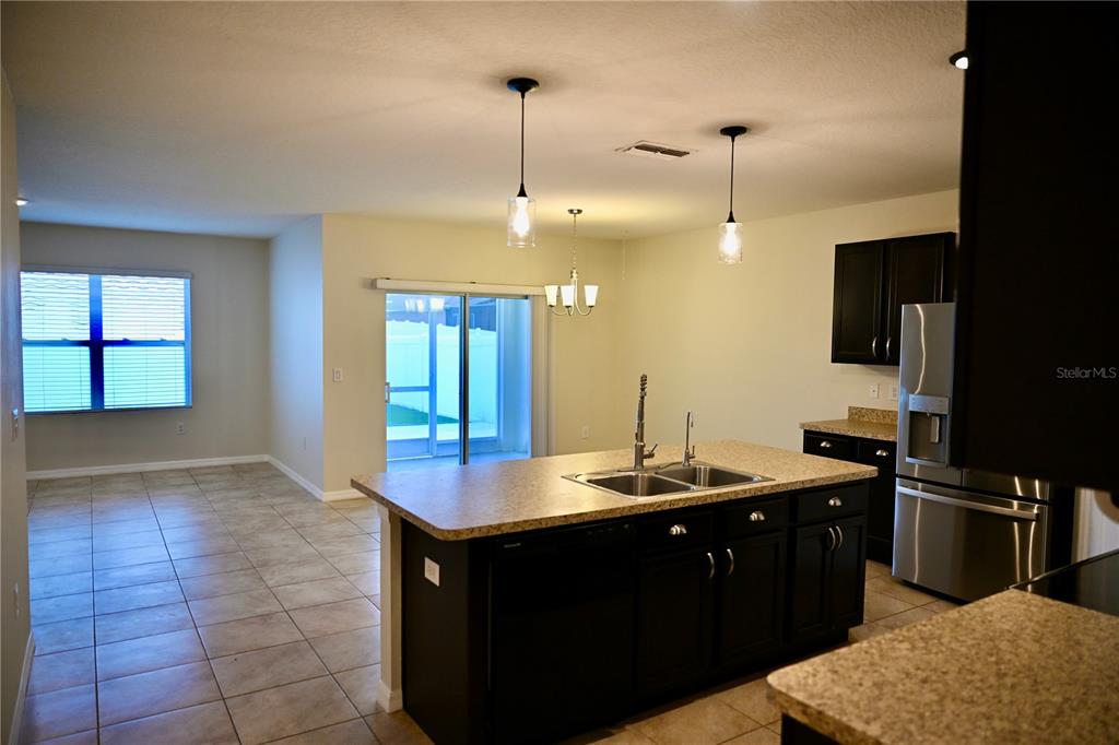 1036 Bethpage Road Auburndale, FL 33823 - Photo 4 of 18 a kitchen with kitchen island a sink stainless steel appliances and a counter top space