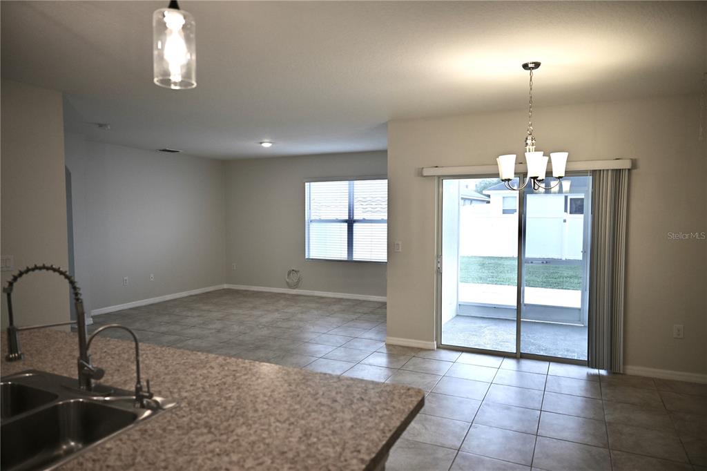 1036 Bethpage Road Auburndale, FL 33823 - Photo 7 of 18 a view of a kitchen with a sink and chandelier