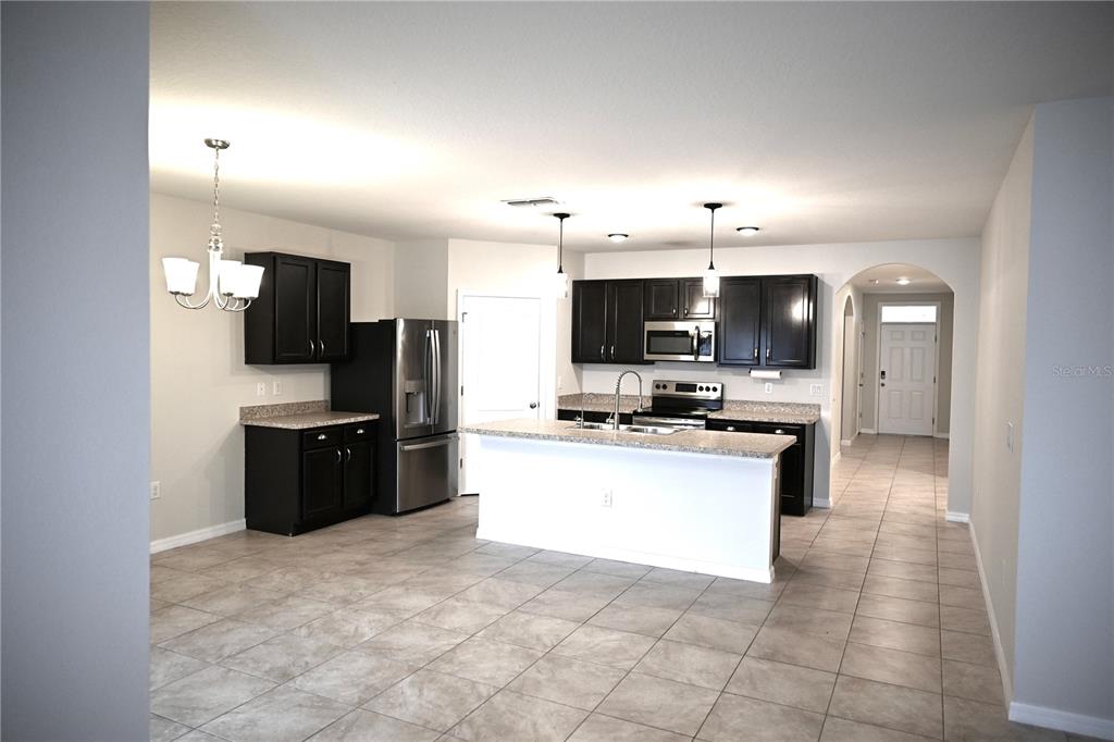 1036 Bethpage Road Auburndale, FL 33823 - Photo 8 of 18 a large kitchen with cabinets