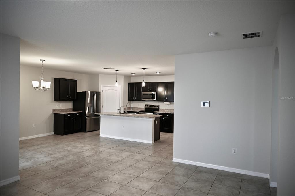 1036 Bethpage Road Auburndale, FL 33823 - Photo 9 of 18 a large white kitchen with a sink and stainless steel appliances