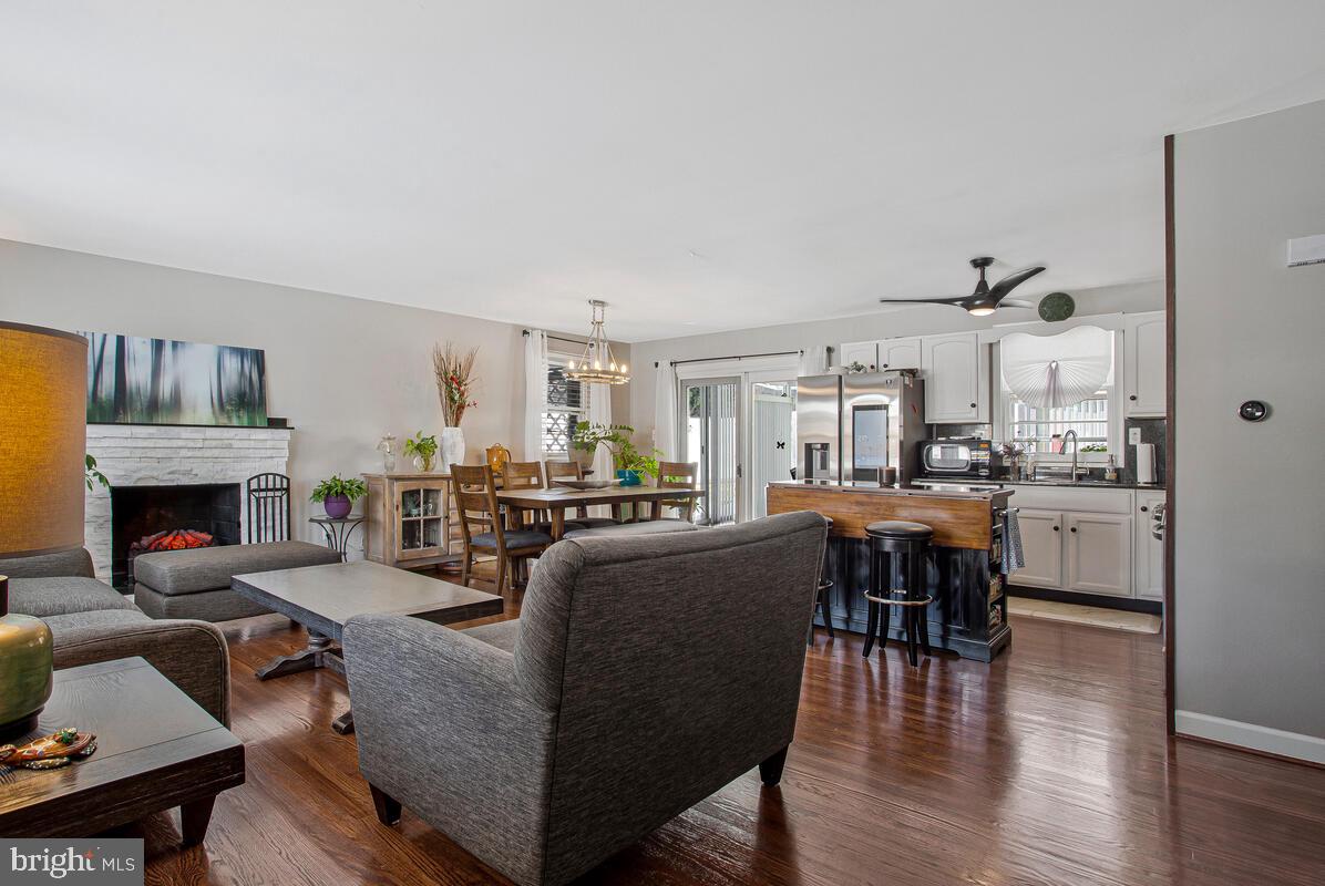 6617 Northgate Parkway Clinton, MD 20735 - Photo 3 of 36 a living room with furniture a fireplace and kitchen view