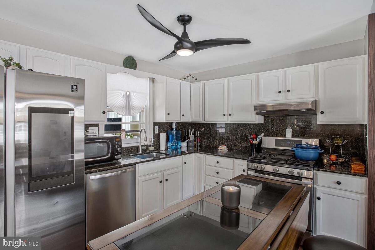 6617 Northgate Parkway Clinton, MD 20735 - Photo 10 of 36 a kitchen with a sink stainless steel appliances and cabinets