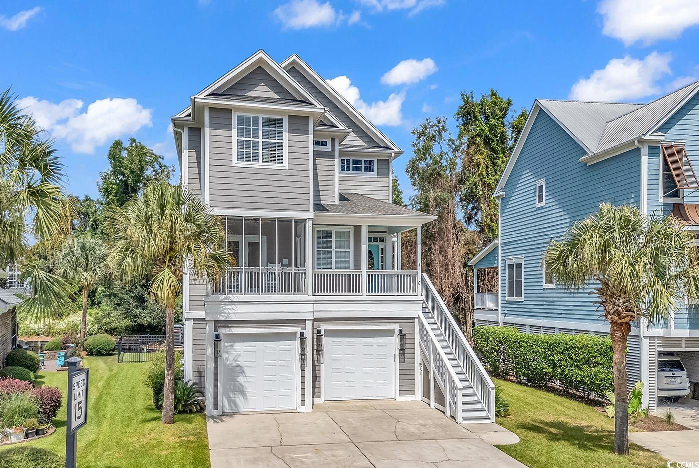 6 Cottage Drive Murrells Inlet, SC 29576 - Photo 1 of 31 Raised beach house with a garage and a front lawn