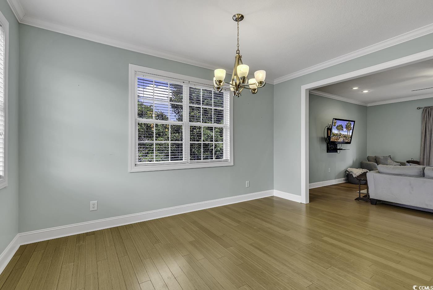 6 Cottage Drive Murrells Inlet, SC 29576 - Photo 11 of 31 Kitchen with light wood-type flooring, cream cabinetry, stainless steel appliances, decorative light fixtures, and sink