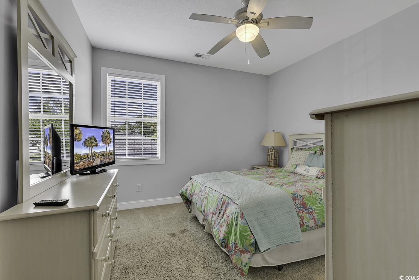 6 Cottage Drive Murrells Inlet, SC 29576 - Photo 17 of 31 Unfurnished bedroom featuring ensuite bath, light colored carpet, crown molding, and ceiling fan