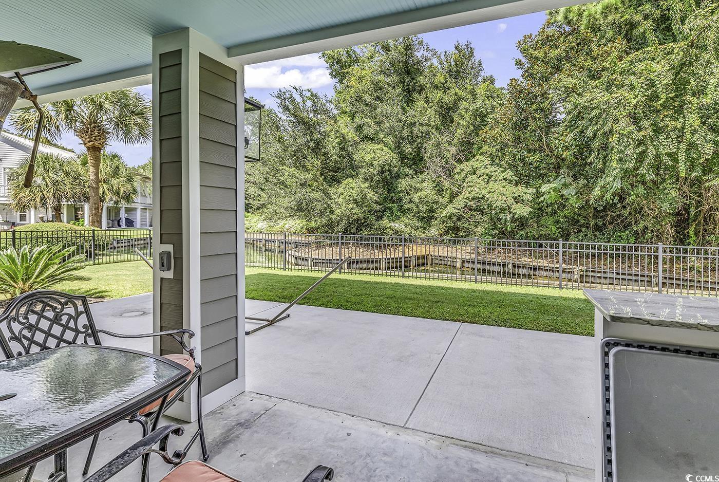 6 Cottage Drive Murrells Inlet, SC 29576 - Photo 27 of 31 Garage featuring a wall mounted AC and ceiling fan
