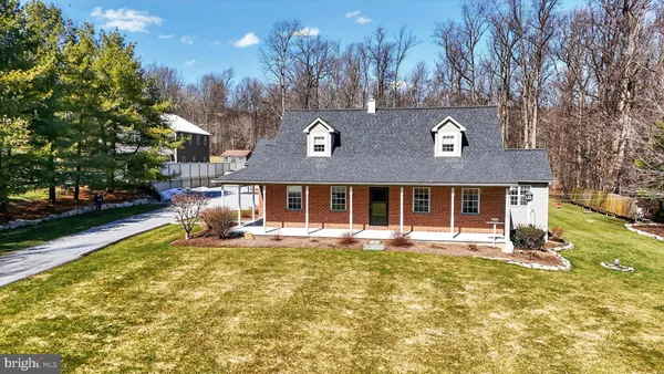 a view of a house with a yard covered in snow