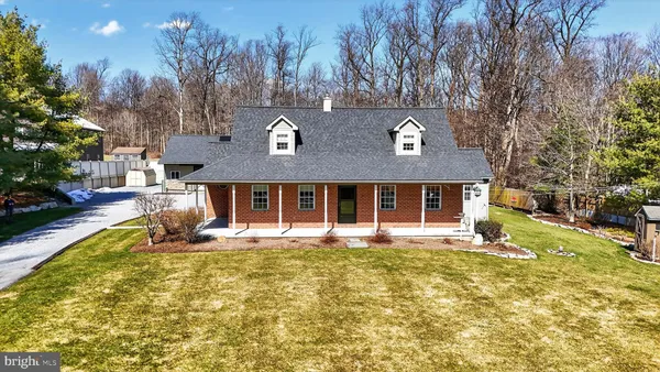 a view of a house with a yard and furniture