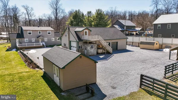 a view of a house with swimming pool next to a yard