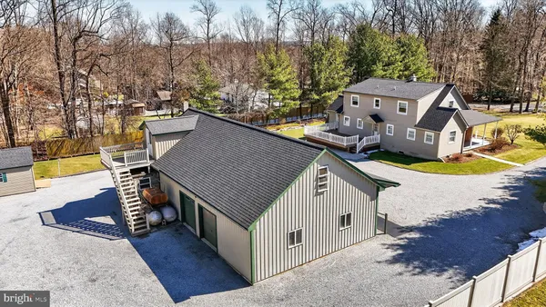 an aerial view of a house with swimming pool and garden view