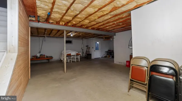 a living room with furniture rug and wooden floor