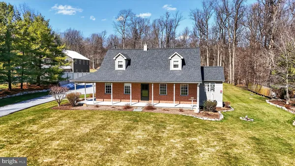 a front view of house with yard and trees around