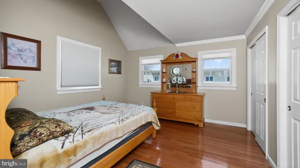 a kitchen with stainless steel appliances granite countertop a stove a refrigerator a kitchen island a sink dishwasher and a dining table with wooden cabinet
