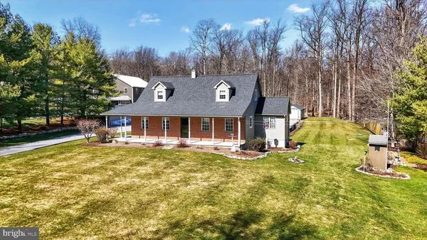a view of a house with a yard patio and fire pit