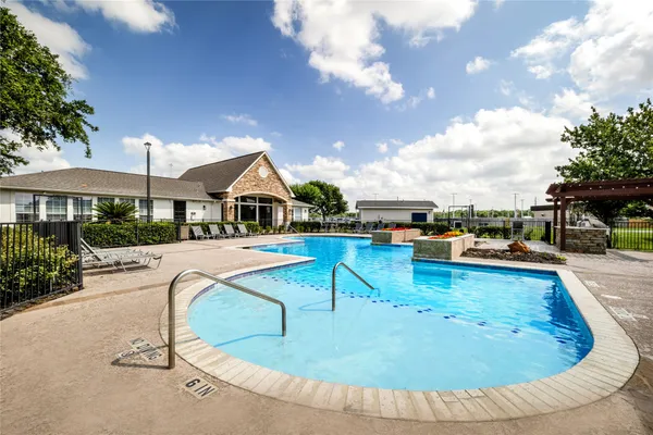 a view of a swimming pool with lounge chair