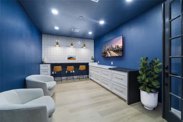 a living room with furniture a potted plant and a fireplace