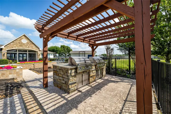 a view of a patio with table and chairs with wooden floor and fence
