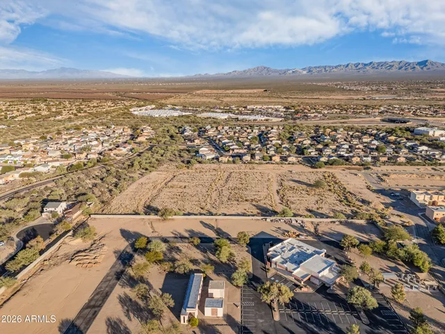 an aerial view of residential building and ocean view in back