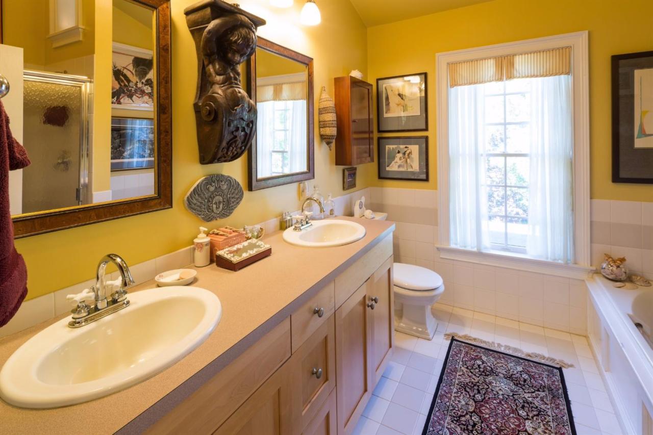 25 Sawyer Grove Road Truro, MA 02666 - Photo 15 of 34 a bathroom with a double vanity sink a mirror and a toilet