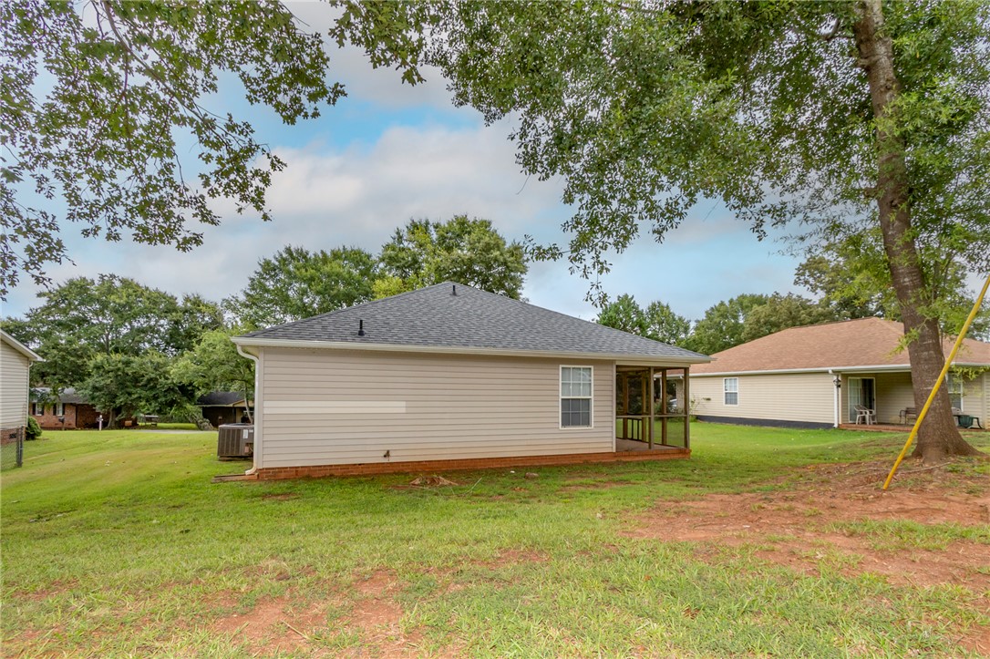 2509 Rolling Green Road Anderson, SC 29621 - Photo 27 of 28 A well-maintained side exterior with a screened porch offers tranquil outdoor living.