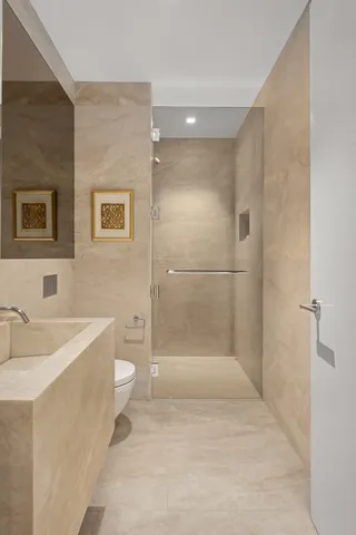 a bathroom with a double vanity sink large mirror and shower