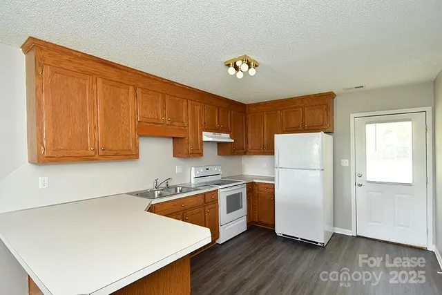 a kitchen with stainless steel appliances a refrigerator sink and cabinets