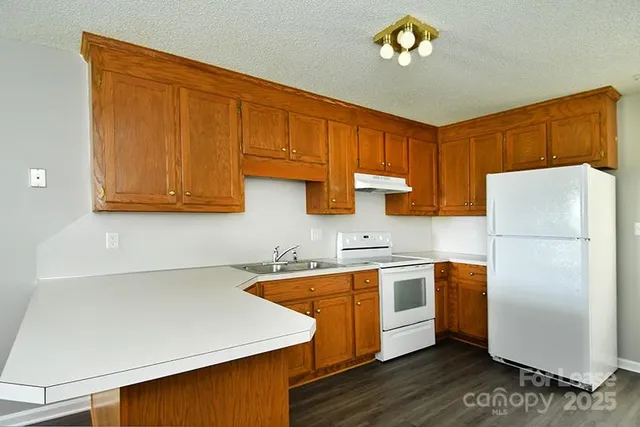 a kitchen with stainless steel appliances a refrigerator sink and cabinets