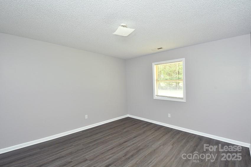 150 Glen-Gar Drive Lincolnton, NC 28092 - Photo 10 of 16 a view of an empty room with wooden floor and a window