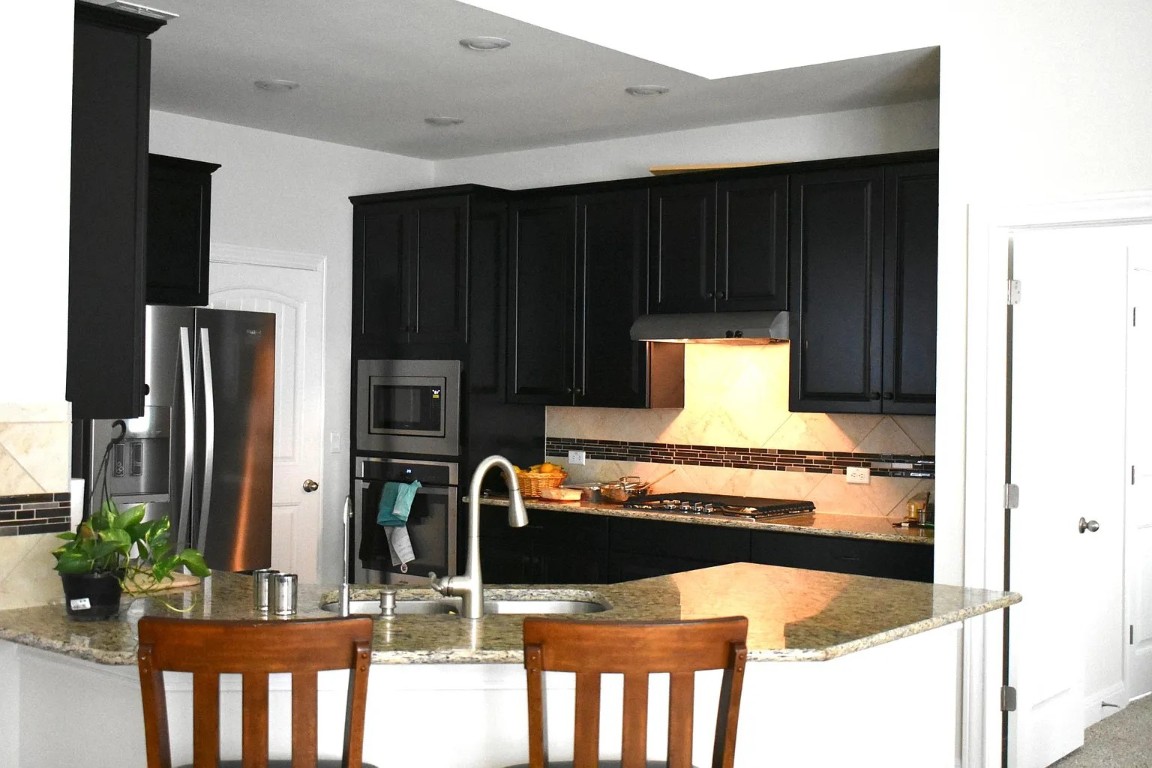 1109 Sundrops Street Leander, TX 78641 - Photo 11 of 40 a kitchen with stainless steel appliances granite countertop a stove and a refrigerator
