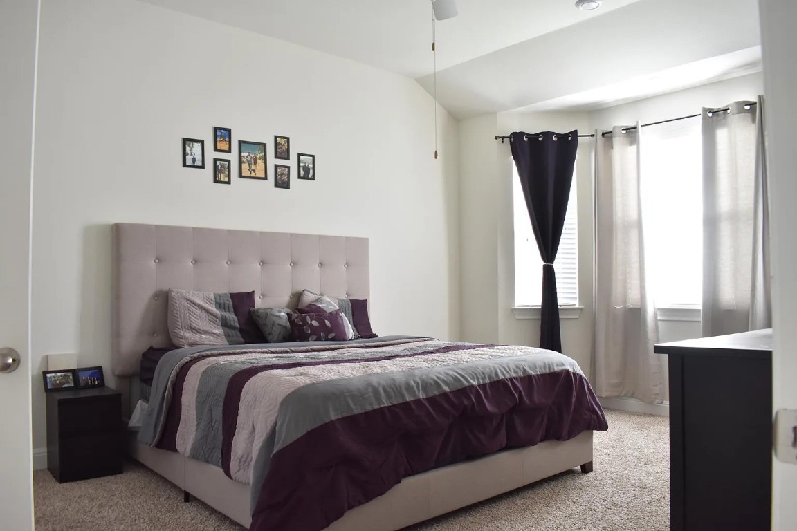 1109 Sundrops Street Leander, TX 78641 - Photo 18 of 40 a bedroom with a large bed and a window