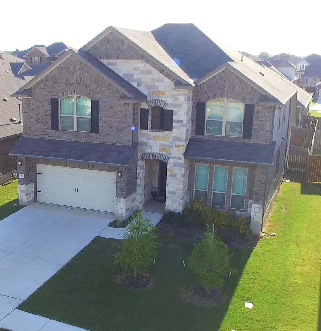 1109 Sundrops Street Leander, TX 78641 - Photo 2 of 40 a front view of a house with a garden and yard