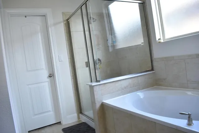 a bathroom with a bathtub and shower