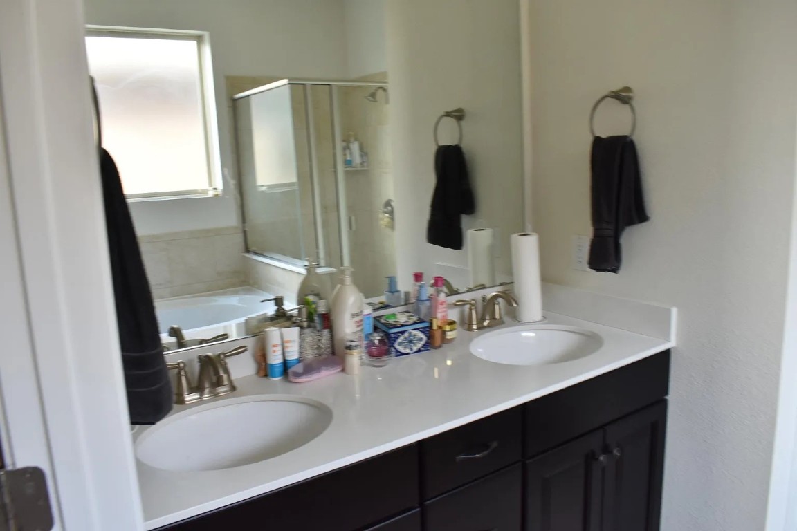1109 Sundrops Street Leander, TX 78641 - Photo 21 of 40 a bathroom with double vanity sink and a mirror