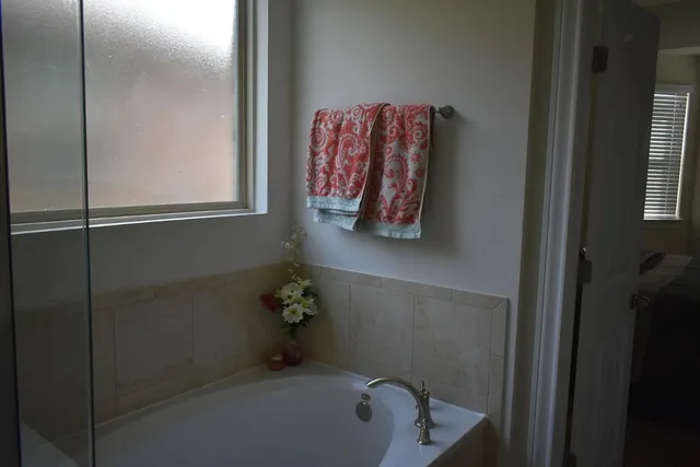 a bath room with a walk in closet