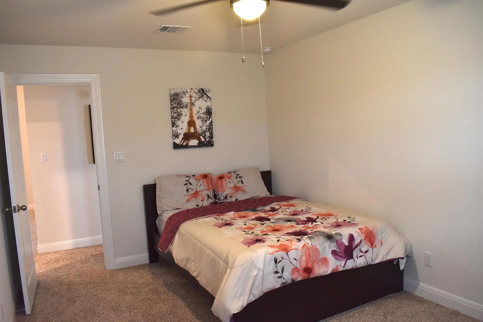 1109 Sundrops Street Leander, TX 78641 - Photo 29 of 40 a bedroom with a bed and a chandelier