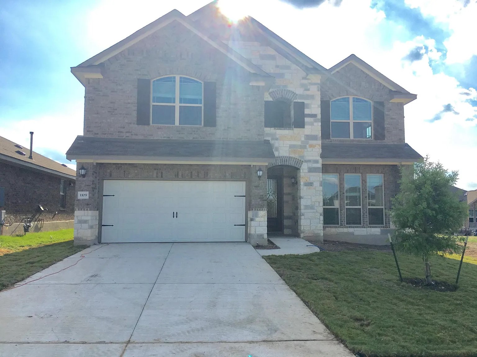 1109 Sundrops Street Leander, TX 78641 - Photo 3 of 40 a front view of a house with large garden
