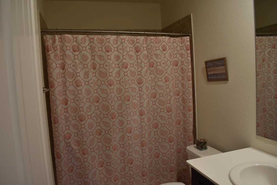 1109 Sundrops Street Leander, TX 78641 - Photo 30 of 40 a bathroom with a sink and a toilet