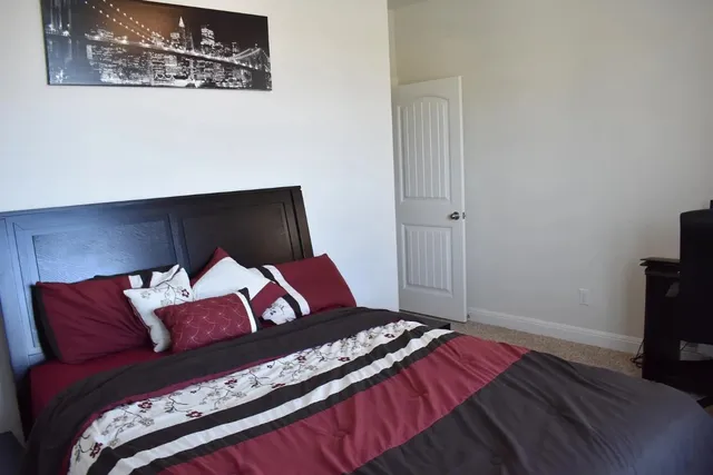 a bedroom with a bed and a television