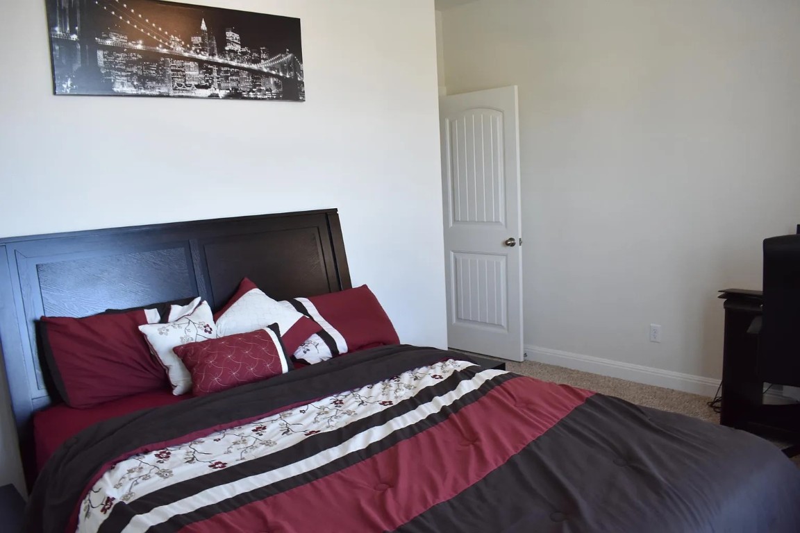 1109 Sundrops Street Leander, TX 78641 - Photo 32 of 40 a bedroom with a bed and a television