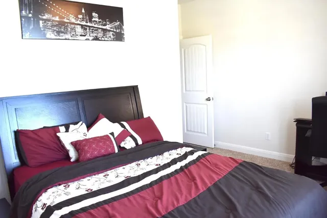 a bedroom with a bed and a flat screen tv